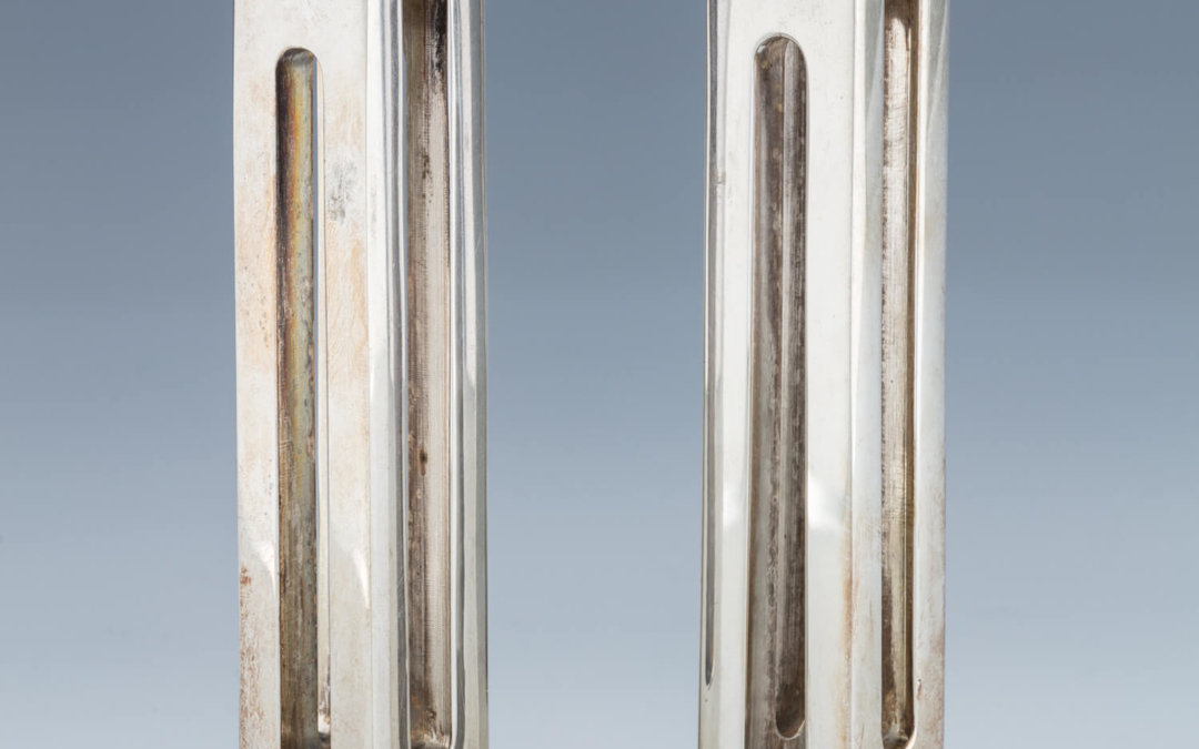 142. A PAIR OF SILVER PLATED CANDLE HOLDERS BY ZELIG SEGAL