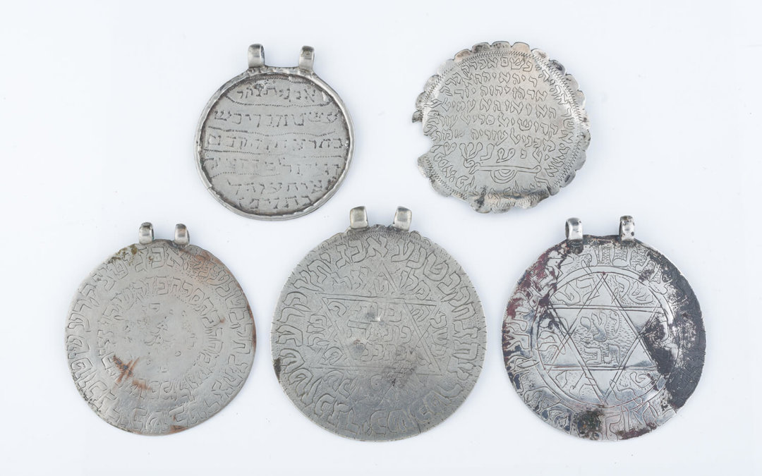 030. A GROUP OF FIVE LARGE CIRCULAR AMULETS