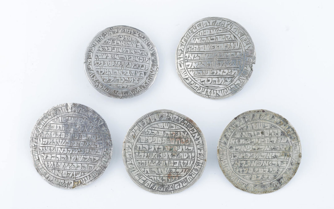 024. A GROUP OF FIVE CIRCULAR SILVER AMULETS